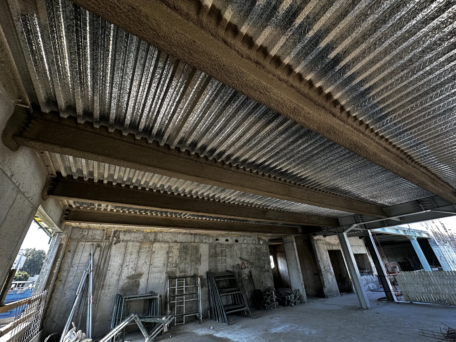 Fireproofed steel beams inside the building — Center of Excellence